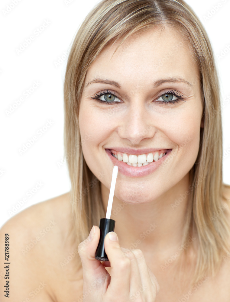 Smiling woman putting gloss Smiling woman putting gloss