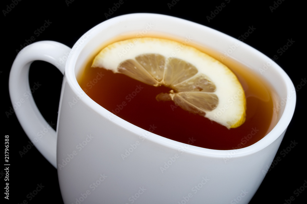 close-up cup of tea with lemon on black close-up cup of tea with lemon on black