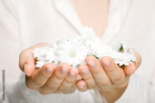 Woman holding white flowers