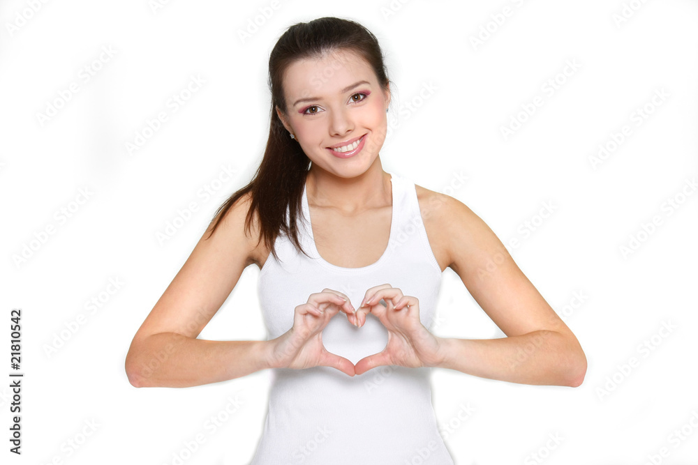 young beautiful girl showing heart symbol over white young beautiful girl showing heart symbol over white