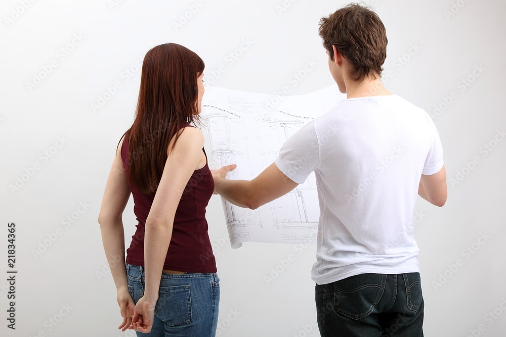 young couple with construction plan young couple with construction plan