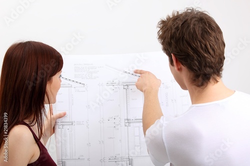 young couple with construction plan