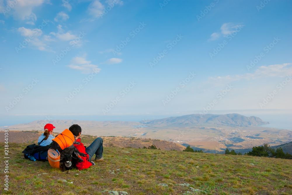 Hikers sit on the slope Hikers sit on the slope