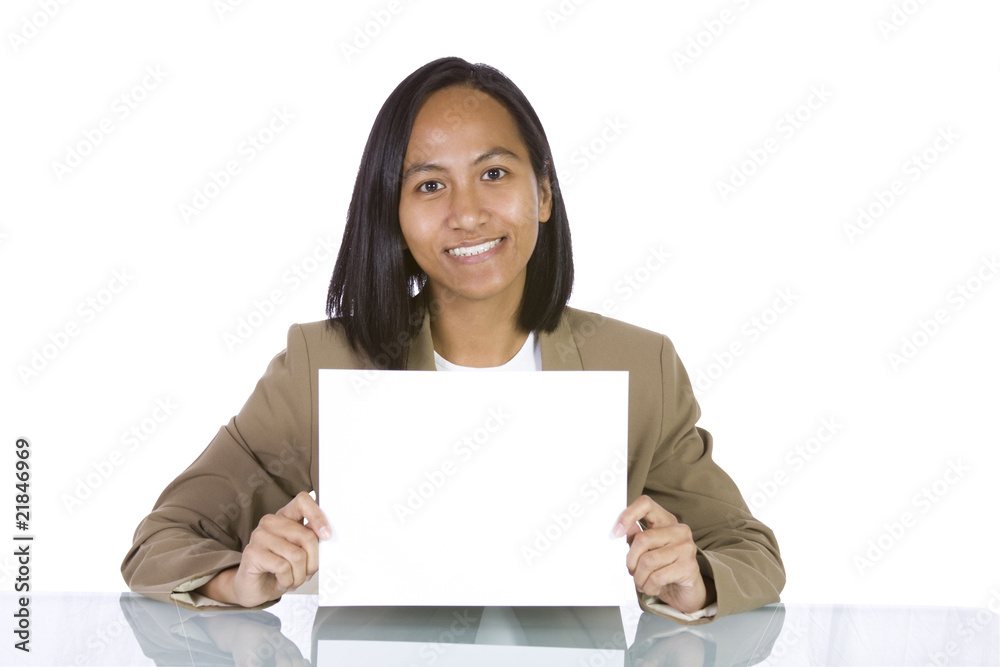 Businesswoman at Her Desk Holding a Blank Sign Businesswoman at Her Desk Holding a Blank Sign
