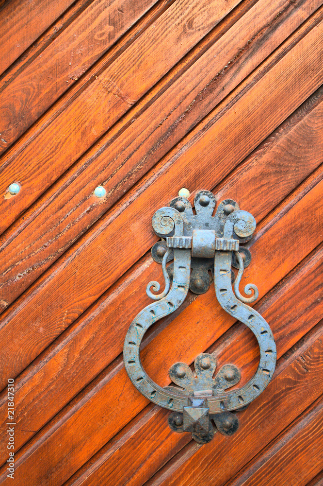 Old rust door knocker on a peeling paint wood door. HDRI image Old rust door knocker on a peeling paint wood door. HDRI image