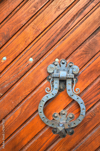 Old rust door knocker on a peeling paint wood door. HDRI image