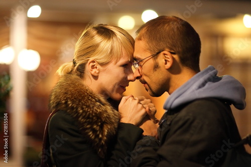 man and woman is cuddling in coldly nightly fall city photo