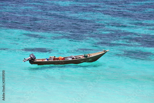 Lonely boat in turquoise sea