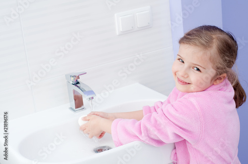 Cute girl washing hands