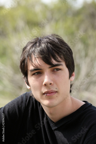 Young teen boy outdoor portrait black hair