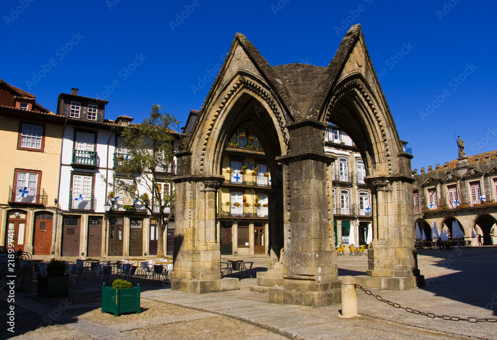 Monument in the centre of Guimares city (Oliveira) with typical