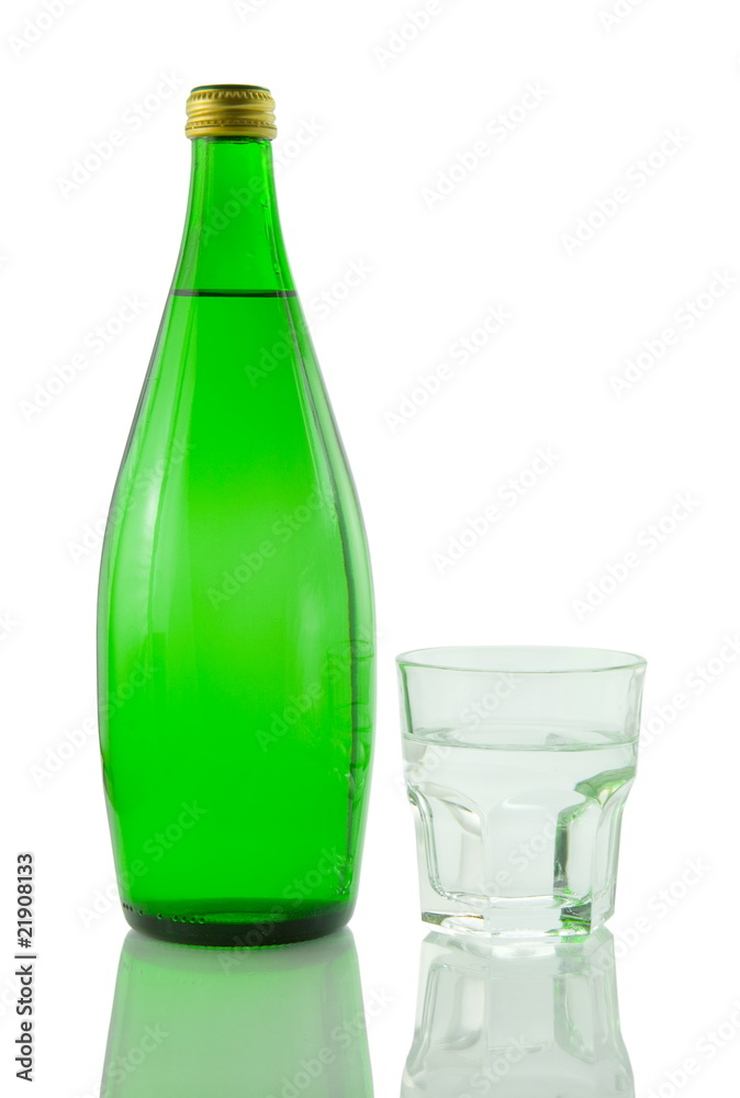 Bottle and glass of mineral water reflected on white background Bottle and glass of mineral water reflected on white background