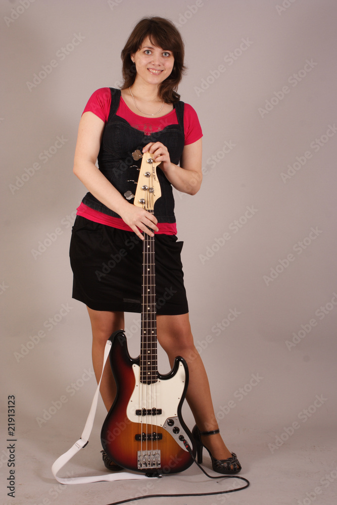 young beautiful woman with a bass guitar