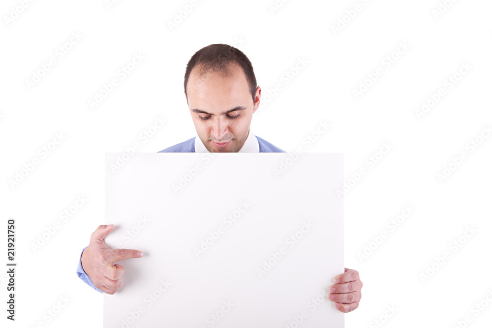 Young businessman holding a white board and pointing Young businessman holding a white board and pointing