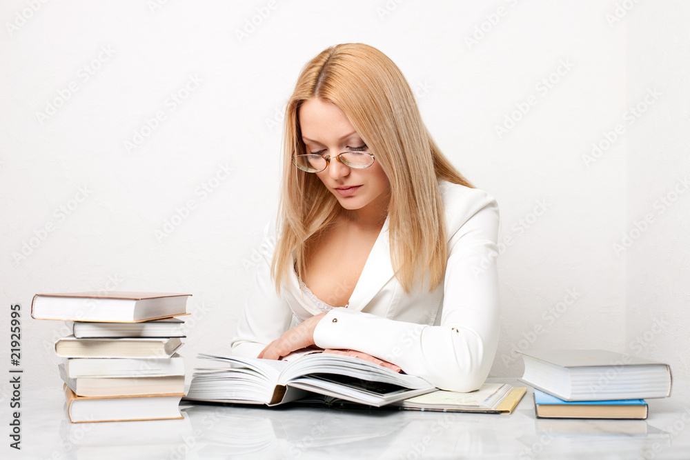 Young pretty woman learning at table with books Young pretty woman learning at table with books