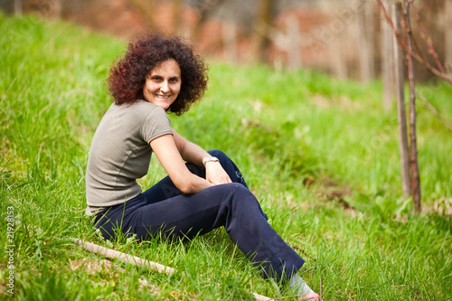 Redhead lady sitting in grass