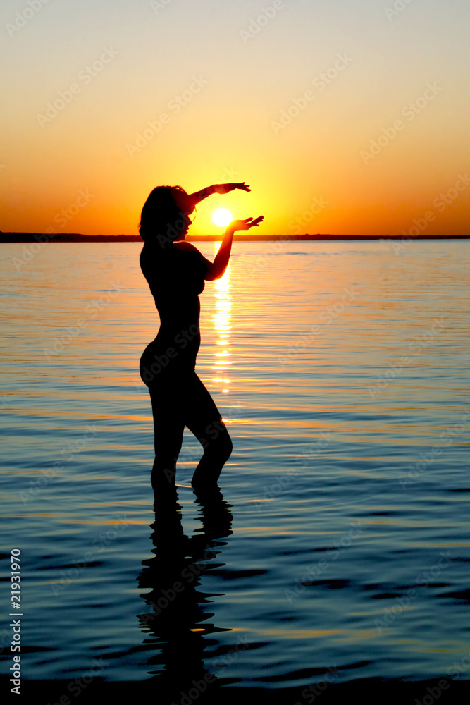Silhouette of woman on sunset in the Baltic sea