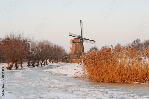 Windmill in Winter With A Frozen Canal photo