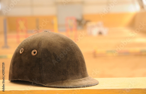 Jockey helmet over riding school background