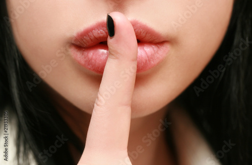 secret. beautiful girl with his finger near the lips