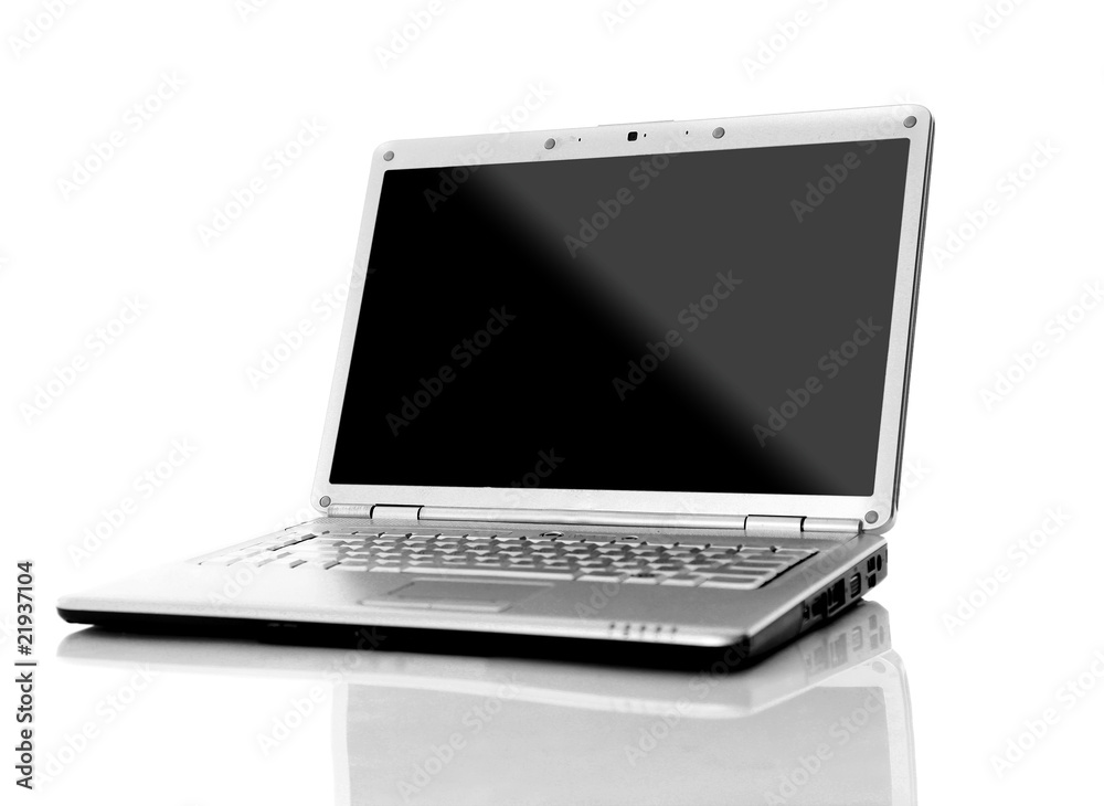 Modern laptop with reflections on glass table.. Modern laptop with reflections on glass table..