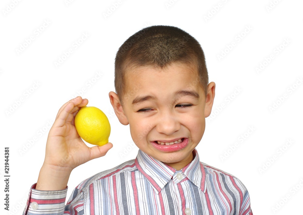 Boy holding a lemon , making a funny face Boy holding a lemon , making a funny face