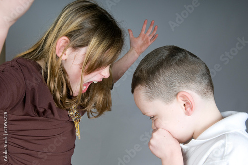 Older girl yelling at boy photo