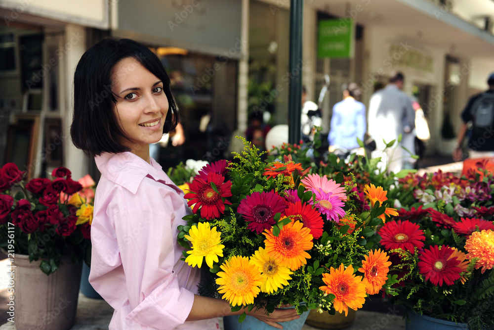 woman with huge bouquet  of  flowers outdoors
