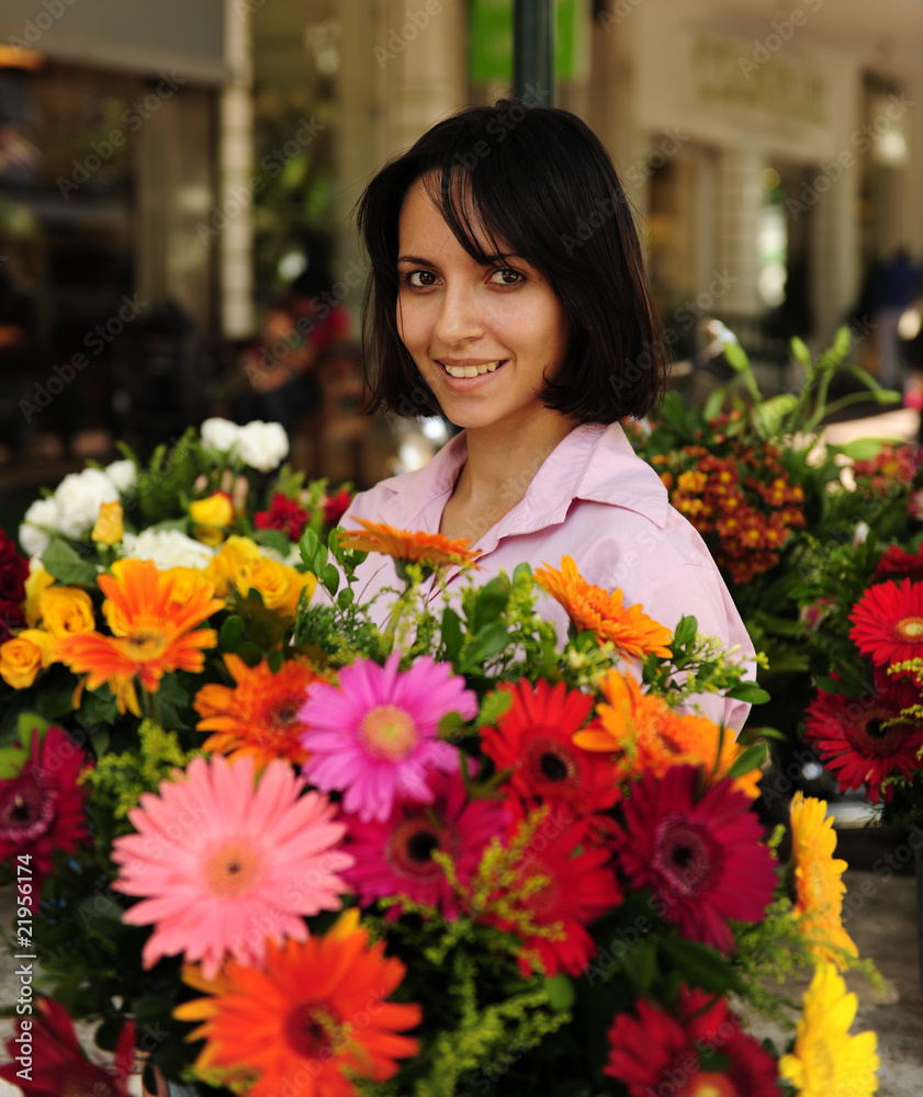 woman with huge bouquet  of  flowers outdoors