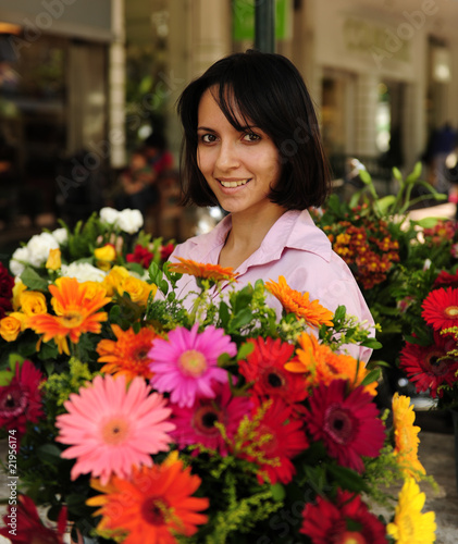 woman with huge bouquet  of  flowers outdoors © mangostock