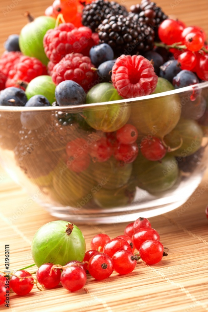 Fruit mix in the glass container, on a table from straw Fruit mix in the glass container, on a table from straw