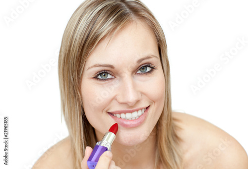Glowing woman putting red lipstick
