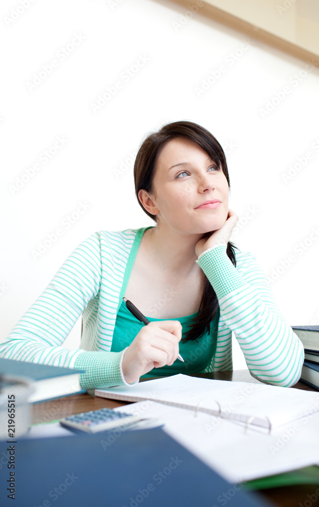 Self-assured teen girl studying at her desk Self-assured teen girl studying at her desk