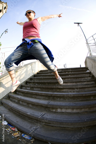 Youth leaping down urban stairs