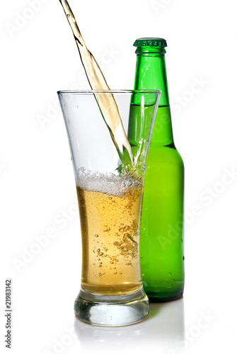 Beer pouring from into glass isolated with bottle on white