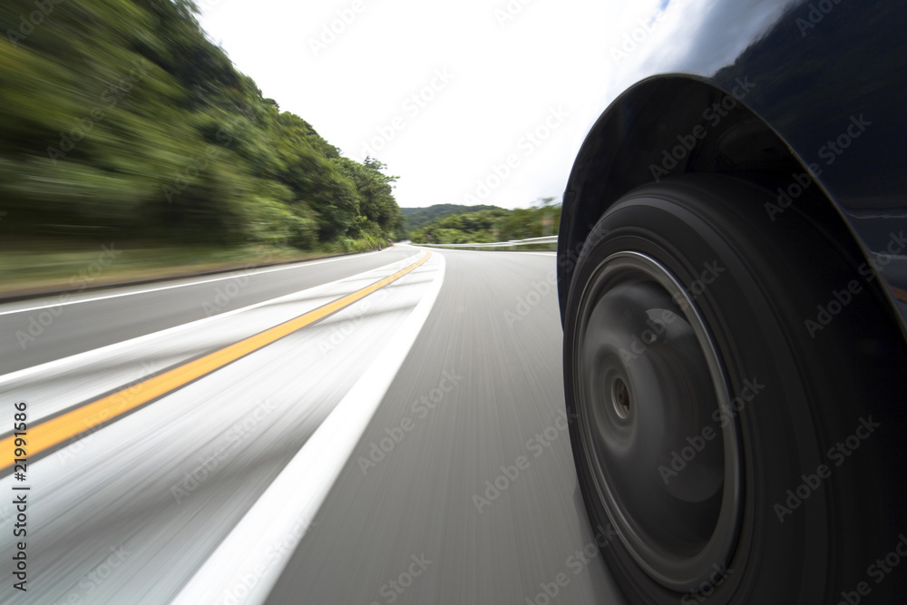The car moves at great speed at the mountain road