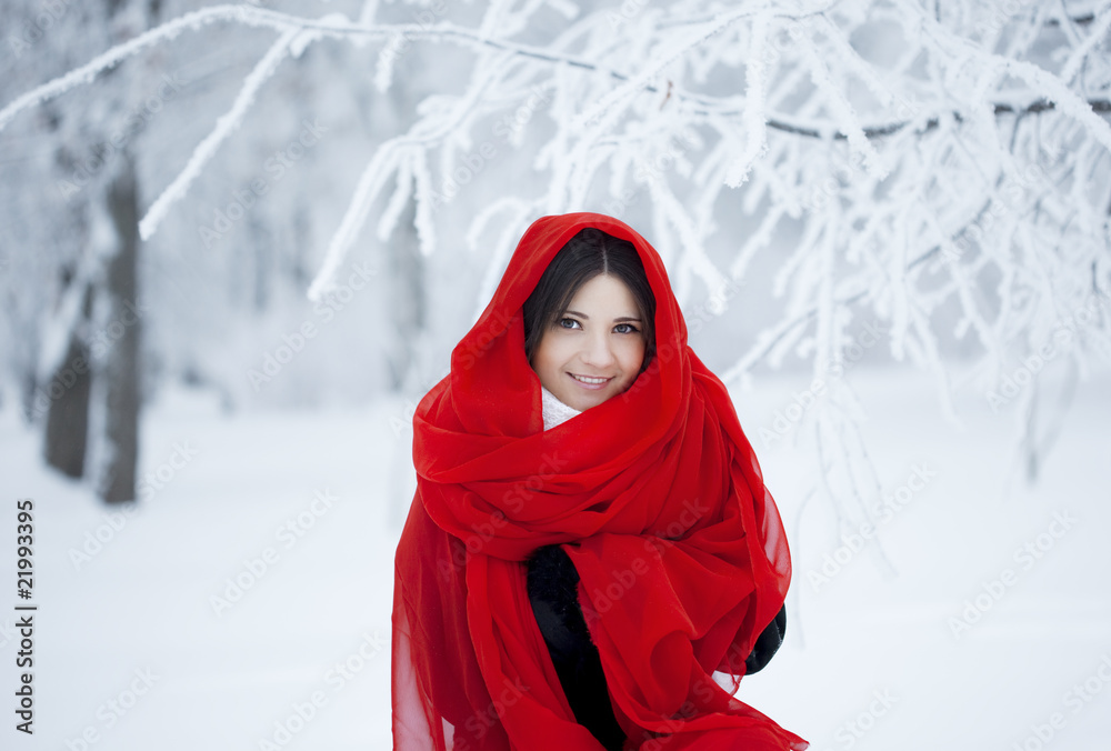 Beautiful girl in winter forest in red Beautiful girl in winter forest in red