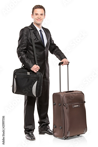 Businessman carrying his laptop and his luggage