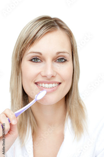 Portrait of a pretty woman brushing her teeth
