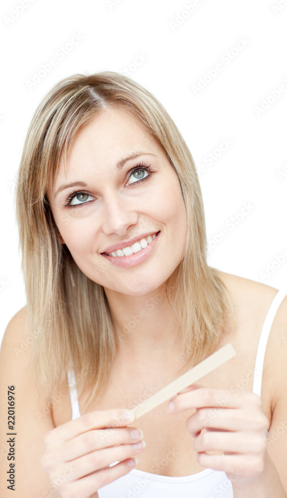 Portrait of a pensive woman filing her nails Portrait of a pensive woman filing her nails