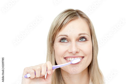 Portrait of an attractive woman brushing her teeth