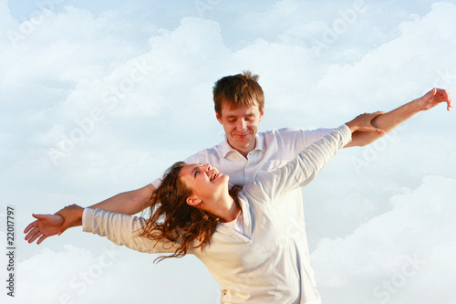 happy couple on sky background