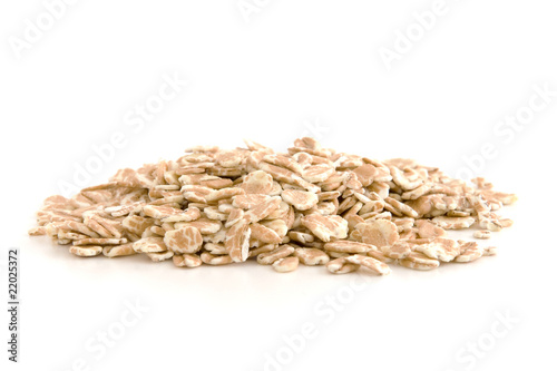 Organic wheat flakes isolated on white background.