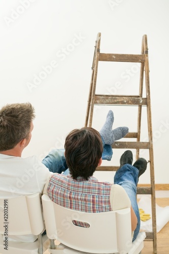 Couple looking at painted wall