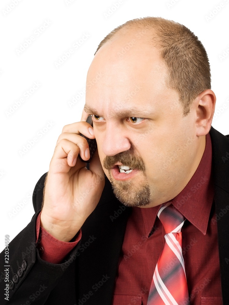 Spiteful businessman talking by mobile phone Spiteful businessman talking by mobile phone