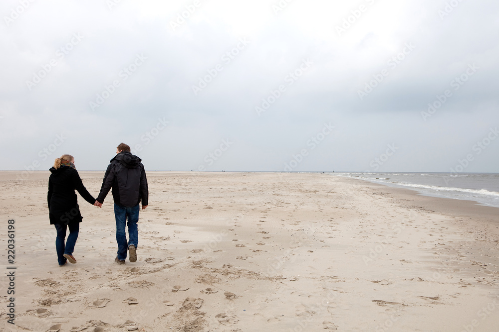 Couple is walking on the beach