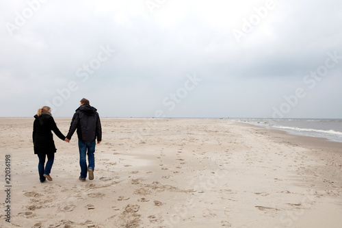 Couple is walking on the beach
