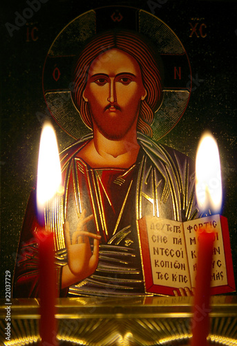 Orthodox icon by the light of two burning candles