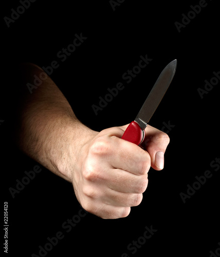 Foto Knife in hand isolated on black background