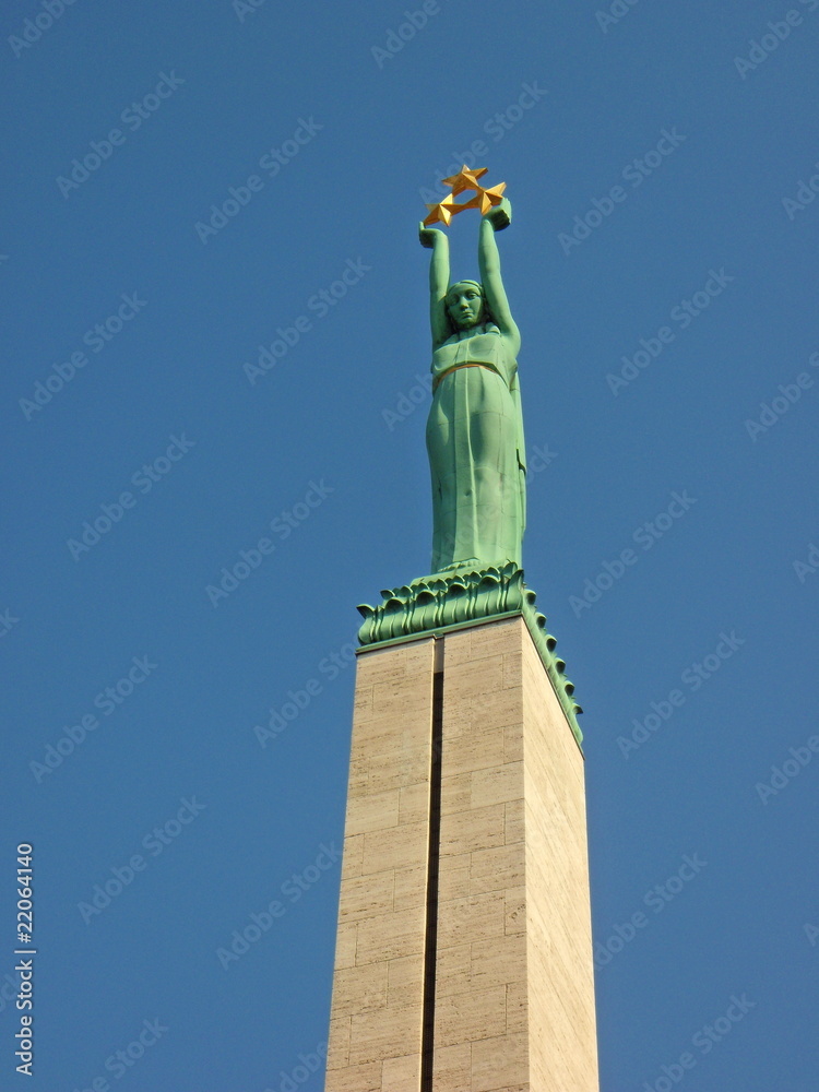 Fototapeta premium Woman's sculpture, holding tree golden stars